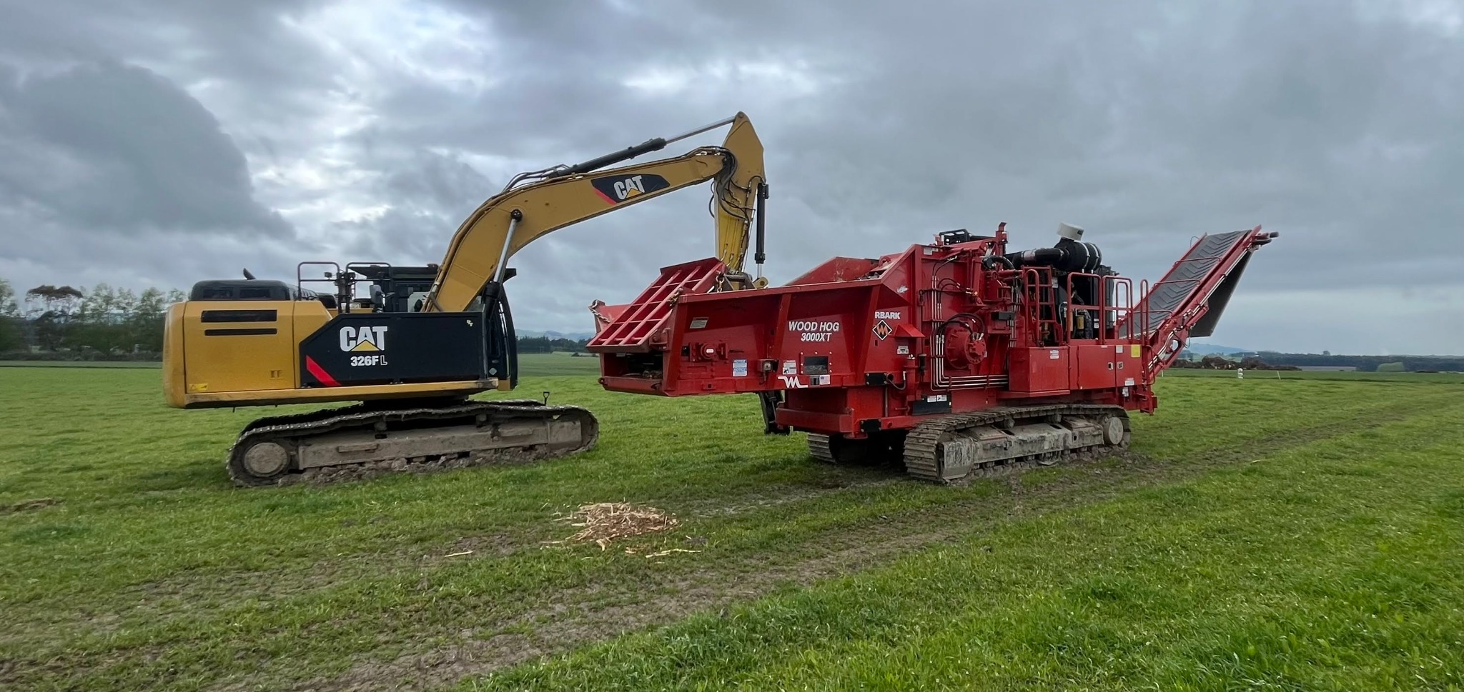 CAT excavator and Morbark forestry equipment